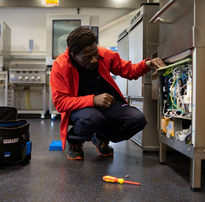 HOBART technician fixing HOBART dishewasher